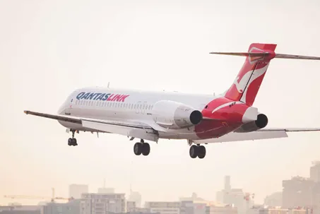 Photograph of QantasLink Boeing B717 aircraft flying